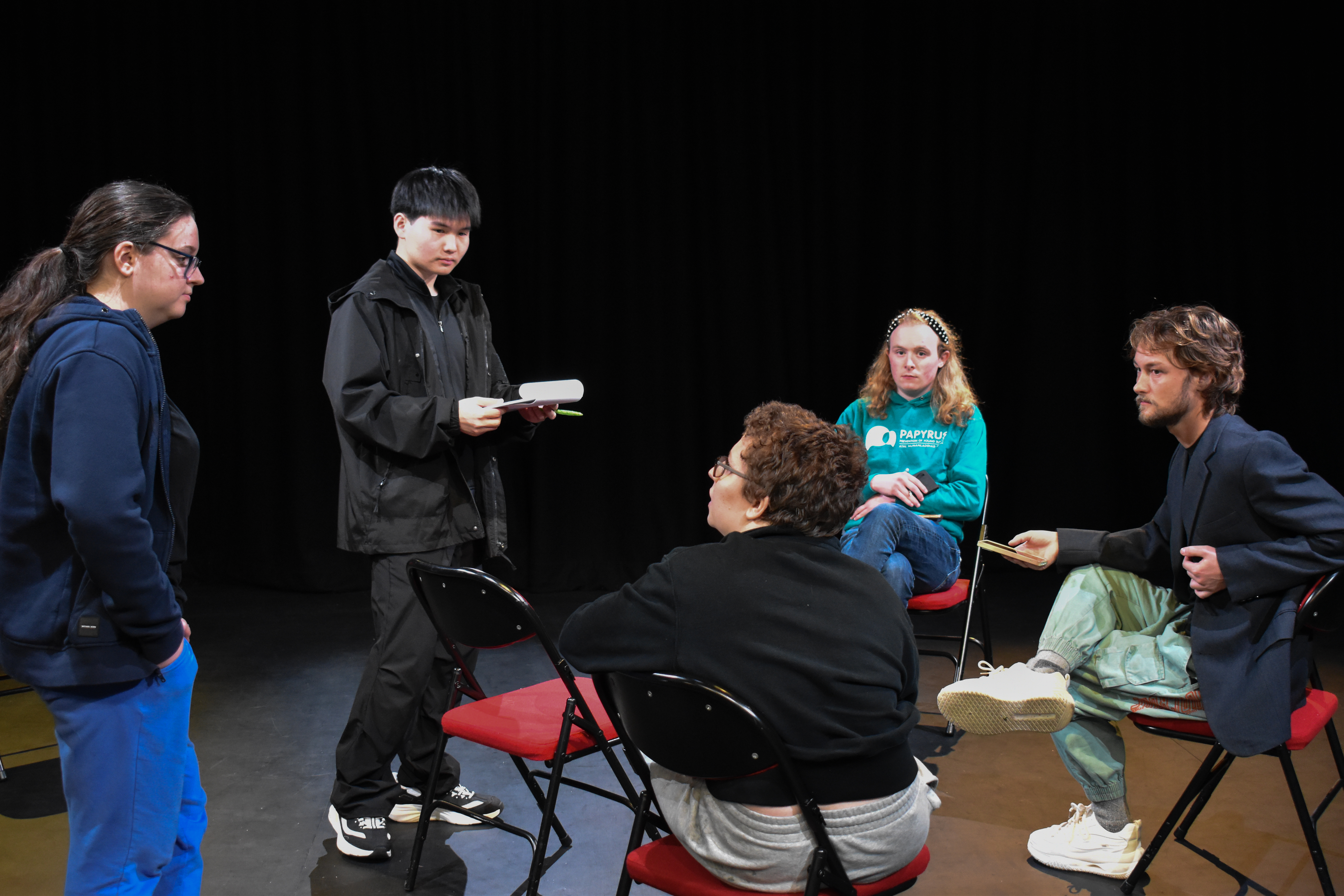 Rehearsal discussion with cast and crew